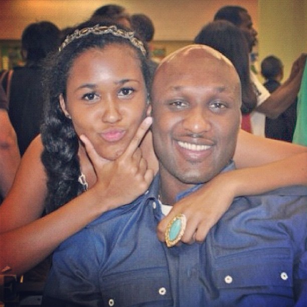 Destiny Odom posing with her father in a blue shirt.